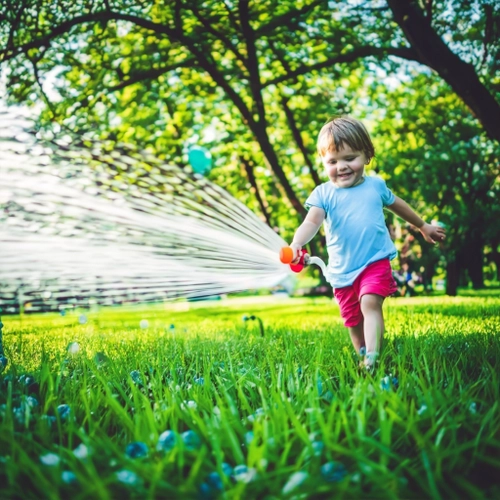 Joyful Child Spraying Water